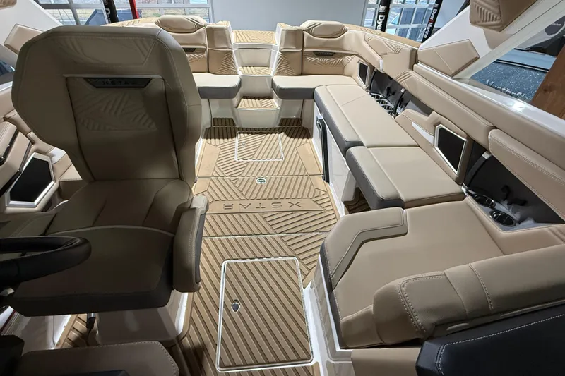  Yacht Photos Pics Luxurious interior of 2025 MasterCraft XStar 23 boat with beige seating and modern design.
