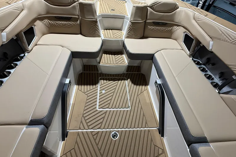 Yacht Photos Pics 2025 MasterCraft XStar 23 interior with beige seating and wood-patterned flooring.