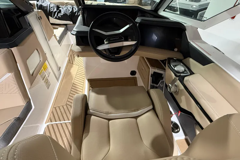  Yacht Photos Pics 2025 MasterCraft XStar 23 boat interior with beige seating and modern steering console.