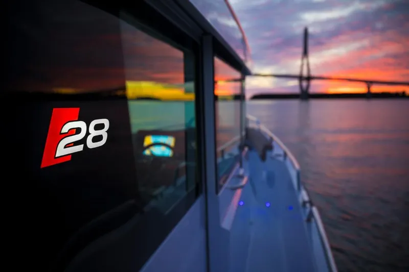  Yacht Photos Pics Axopar 28 CABIN boat at sunset on the water.