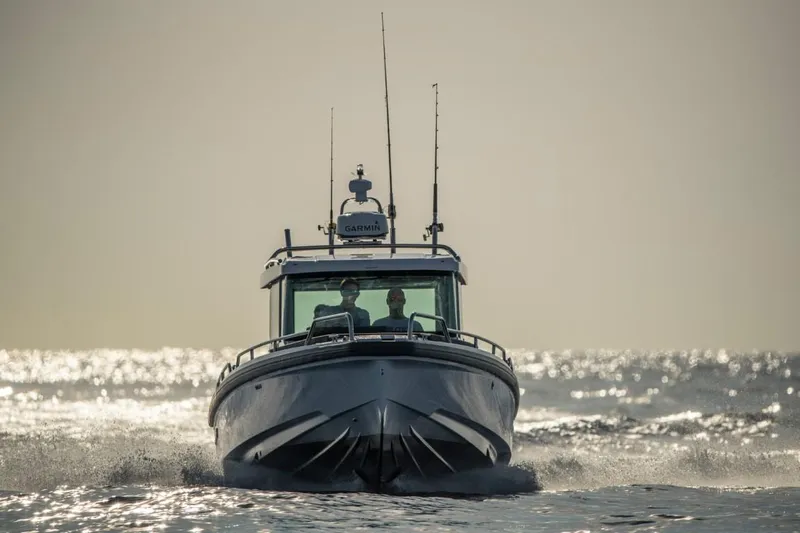  Yacht Photos Pics Axopar 28 CABIN 2022 cruising on open sea at sunset.