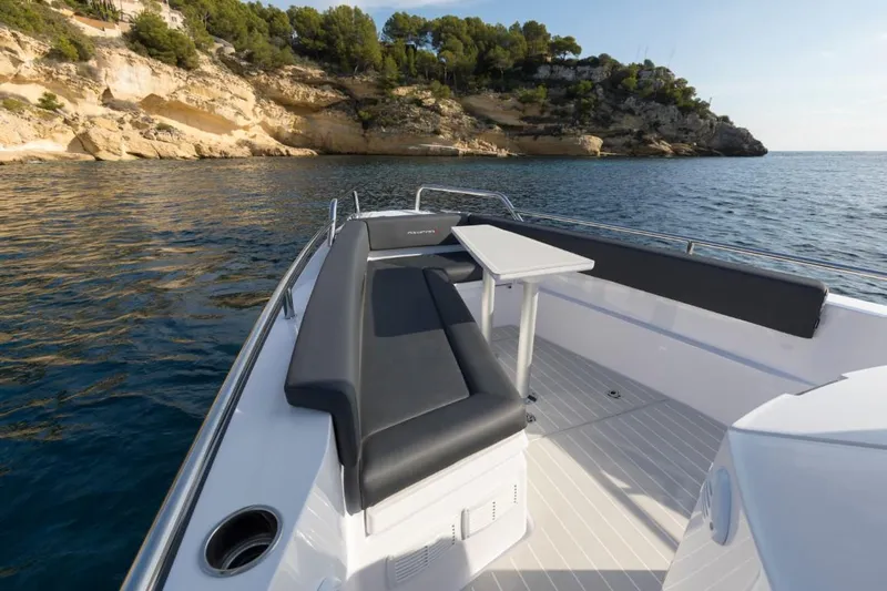  Yacht Photos Pics Axopar 28 CABIN 2022 boat near rocky coastline.