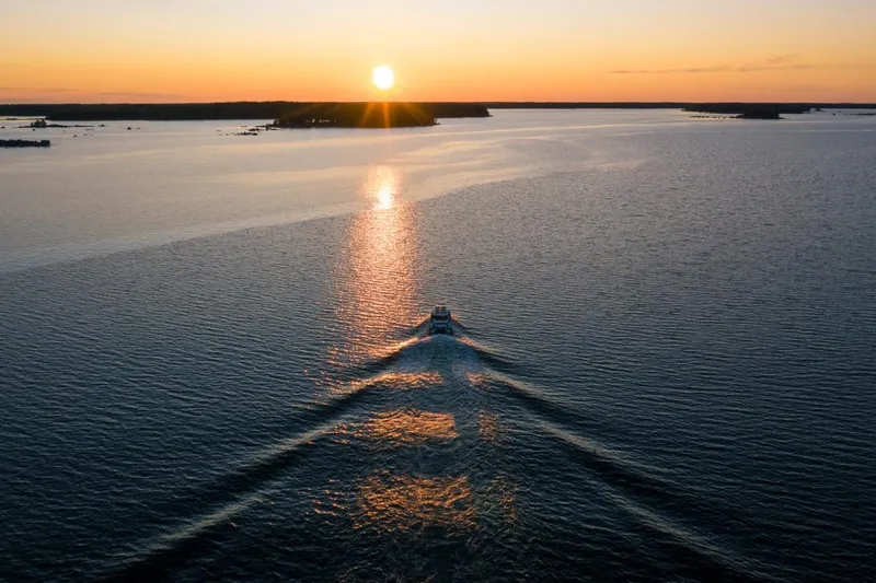  Yacht Photos Pics Axopar 28 CABIN 2022 cruising at sunset on the sea.