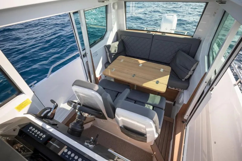  Yacht Photos Pics Interior of 2022 Axopar 28 CABIN with seating and table.