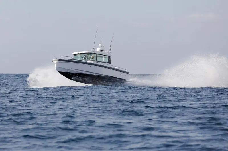 Yacht Photos Pics Axopar 28 CABIN 2022 cruising on open sea.