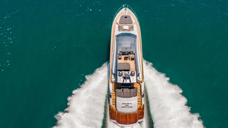 Double Or Nothing Yacht Photos Pics Aerial view of 2017 Pershing 82 VHP yacht cruising on blue water.