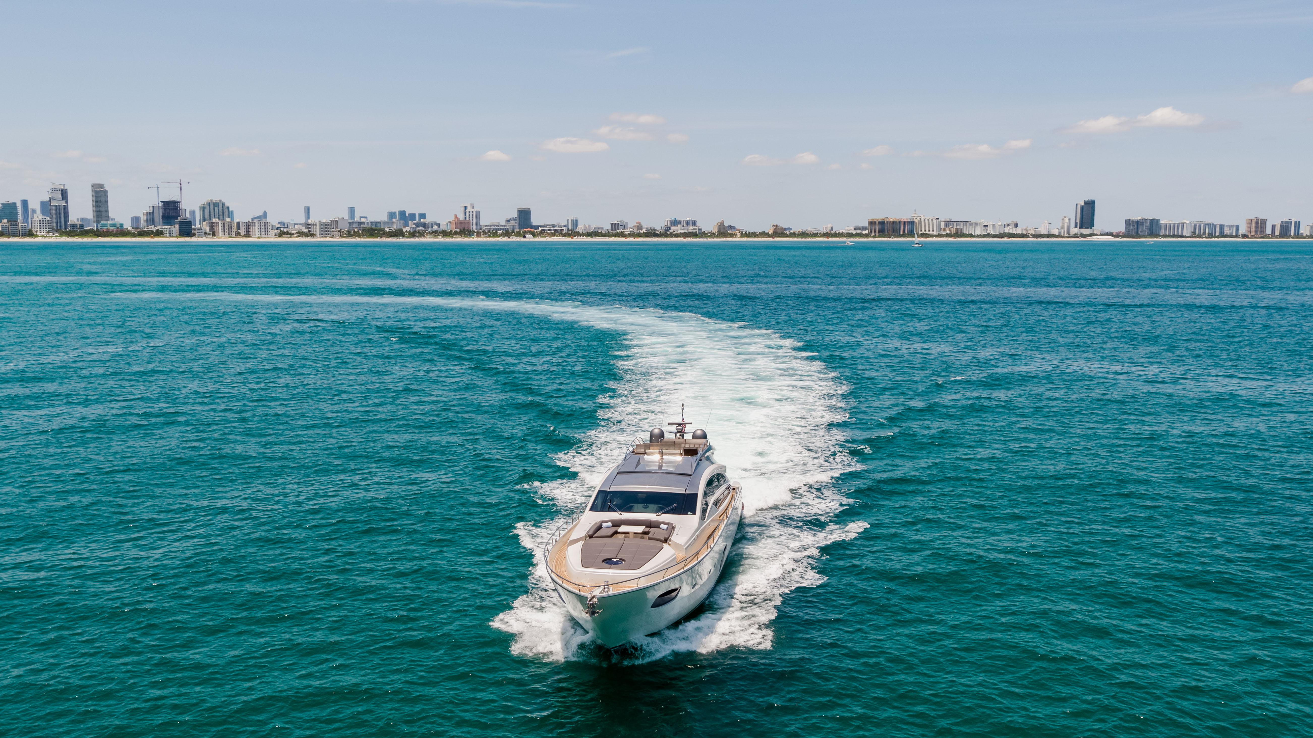 2017 Pershing 82 VHP yacht cruising in open water near city skyline.