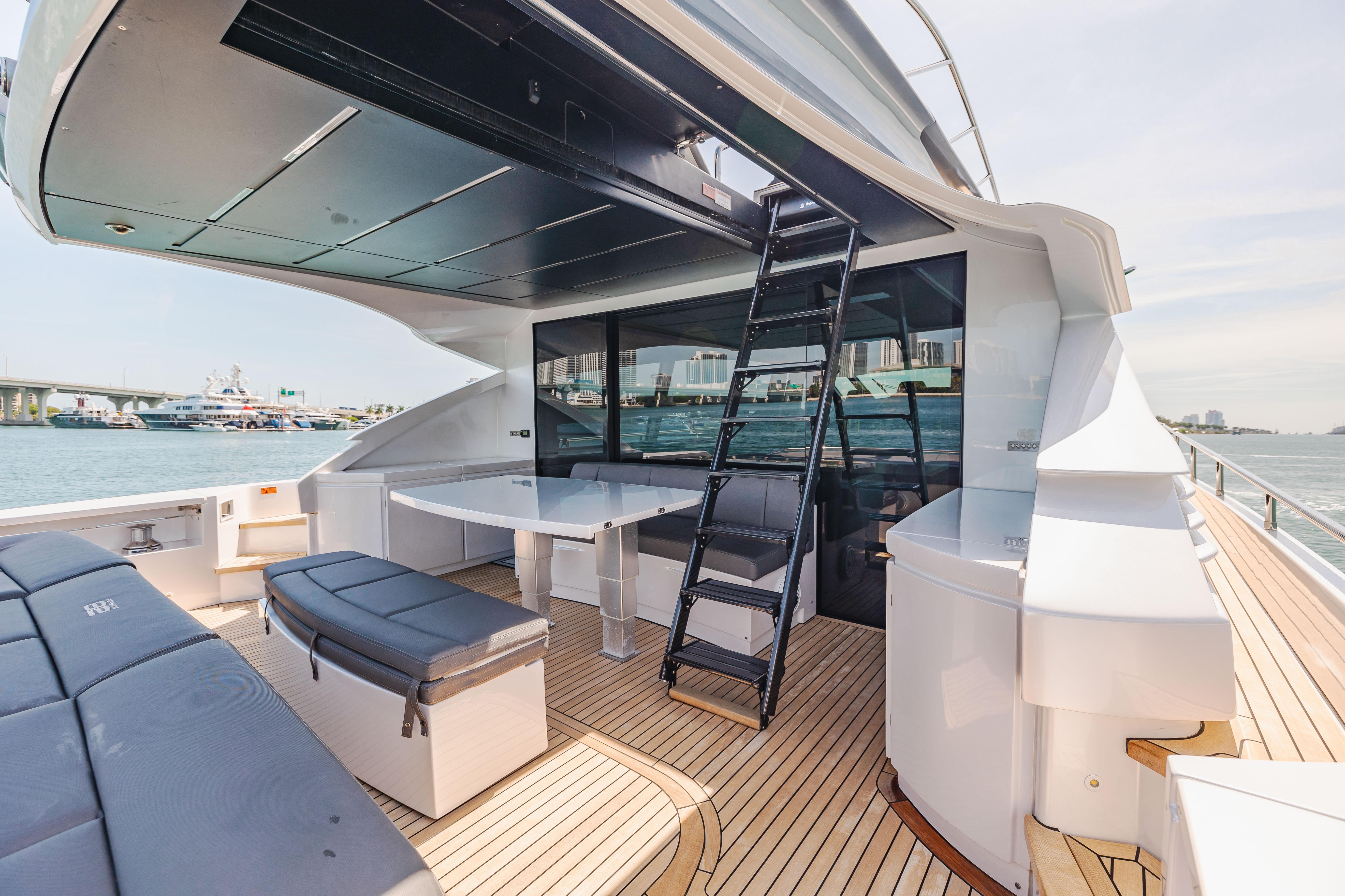 Luxury 2017 Pershing 82 VHP yacht deck with seating and ladder.