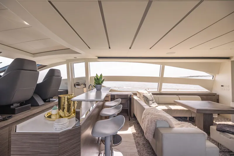 Double Or Nothing Yacht Photos Pics Luxurious interior of 2017 Pershing 82 VHP yacht with modern seating and panoramic windows.