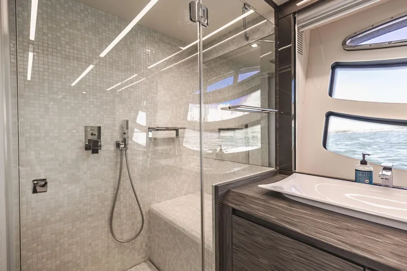 Double Or Nothing Yacht Photos Pics Modern bathroom on 2017 Pershing 82 VHP yacht with glass shower and ocean view.