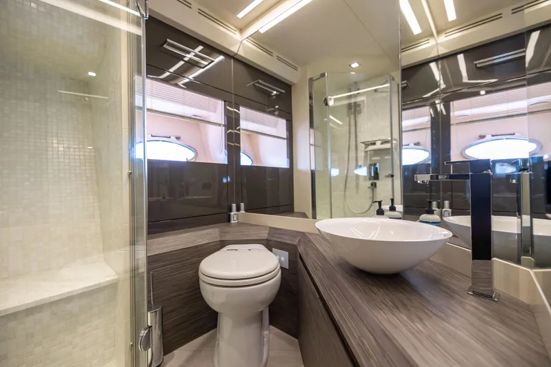 Double Or Nothing Yacht Photos Pics Modern bathroom in 2017 Pershing 82 VHP yacht with glass shower and vessel sink.