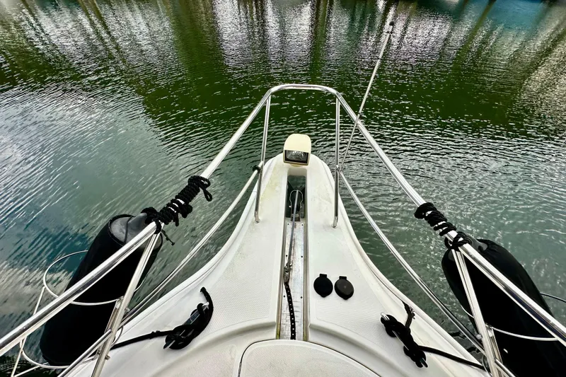  Yacht Photos Pics Bow view of 2005 Silverton 43 Motor Yacht on calm water.
