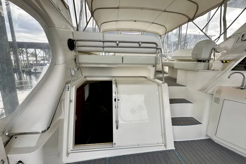  Yacht Photos Pics 2005 Silverton 43 Motor Yacht interior with stairs and seating area, docked at marina.