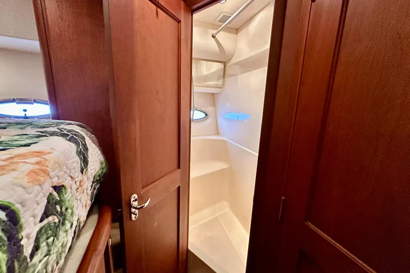  Yacht Photos Pics 2005 Silverton 43 Motor Yacht interior with wooden door and compact shower.
