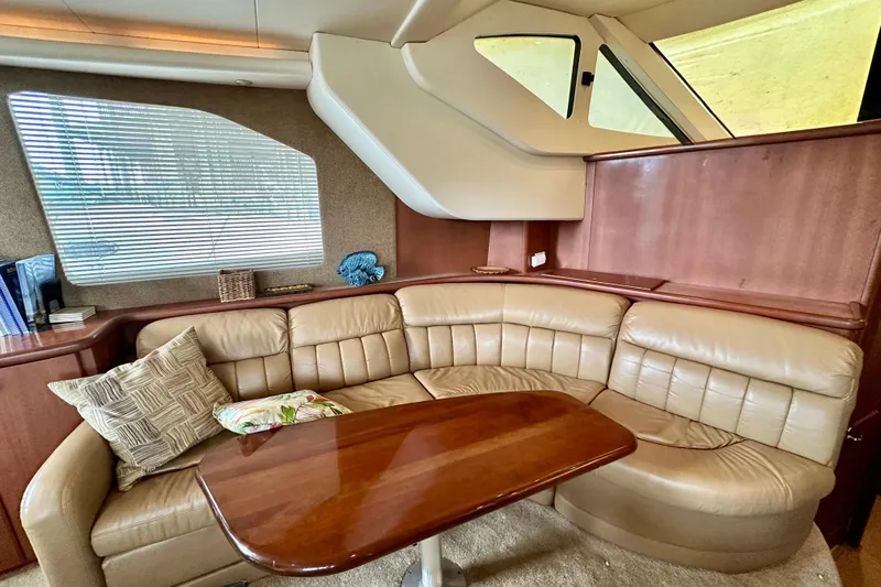  Yacht Photos Pics Luxurious interior of 2005 Silverton 43 Motor Yacht with leather seating and wooden table.