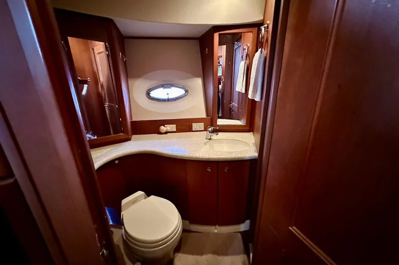  Yacht Photos Pics 2005 Silverton 43 Motor Yacht bathroom with wooden cabinetry and modern fixtures.