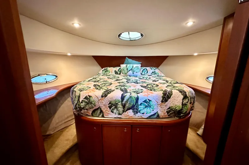  Yacht Photos Pics Luxurious bedroom in 2005 Silverton 43 Motor Yacht with floral bedding and elegant lighting.
