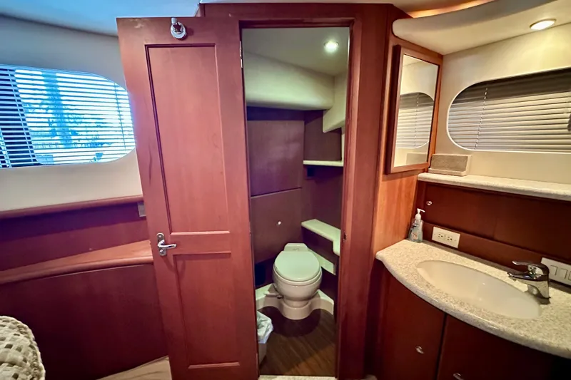  Yacht Photos Pics 2005 Silverton 43 Motor Yacht bathroom with wooden cabinetry and modern fixtures.