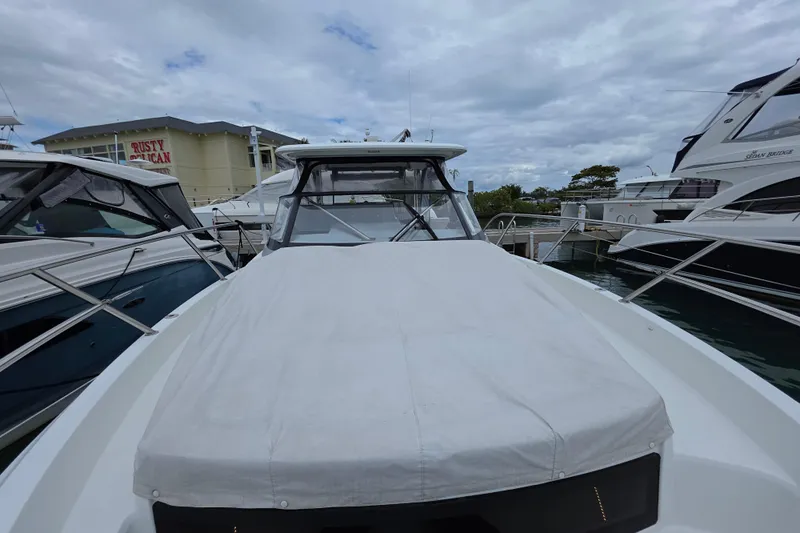  Yacht Photos Pics 2022 Jeanneau Leader 10.5 WA Series 2 docked at marina under cloudy sky.