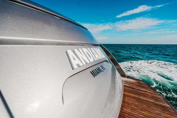 Andiamo Yacht Photos Pics Luxury Pershing 70 yacht cruising on ocean, rear view, 2015 model.