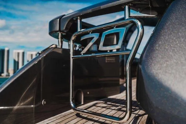 Andiamo Yacht Photos Pics 2015 Pershing 70 yacht detail with chrome railing and city skyline background.