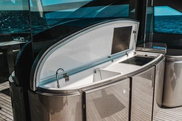 Andiamo Yacht Photos Pics Luxurious 2015 Pershing 70 yacht interior with open bar area and ocean view.