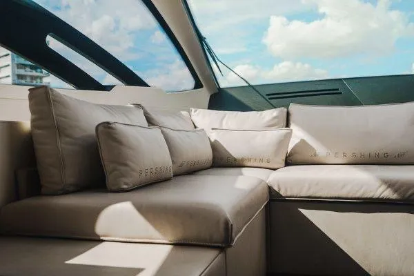 Andiamo Yacht Photos Pics Luxurious interior of a 2015 Pershing 70 yacht with plush seating and cushions.