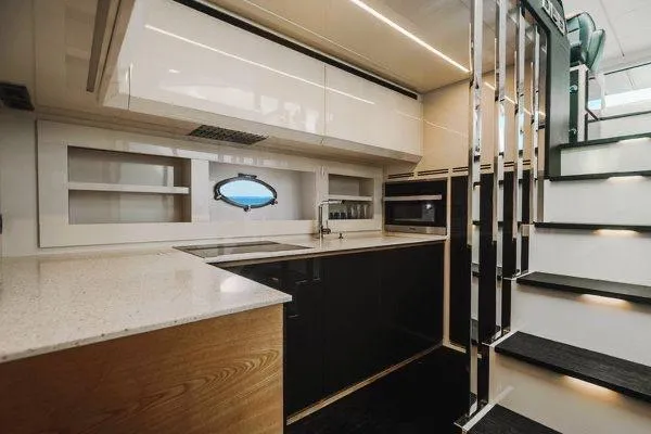 Andiamo Yacht Photos Pics Luxurious kitchen interior of a 2015 Pershing 70 yacht, featuring modern design and sleek finishes.