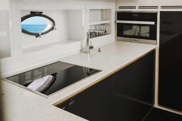 Andiamo Yacht Photos Pics Modern kitchen interior on 2015 Pershing 70 yacht, featuring sleek appliances and ocean view.