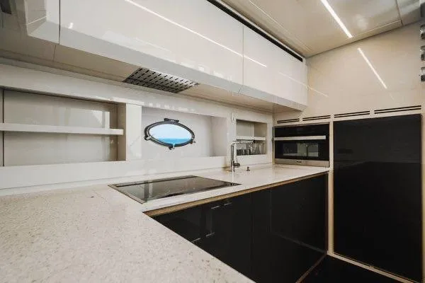 Andiamo Yacht Photos Pics Modern kitchen interior on a 2015 Pershing 70 yacht, featuring sleek cabinetry and appliances.