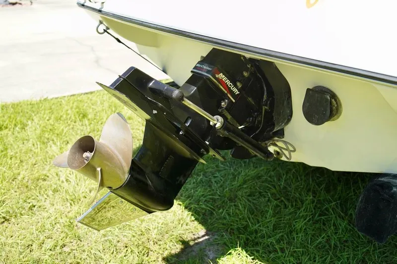 Yacht Photos Pics Propeller and outboard motor of a 2001 Stingray 240 LS boat on grass.