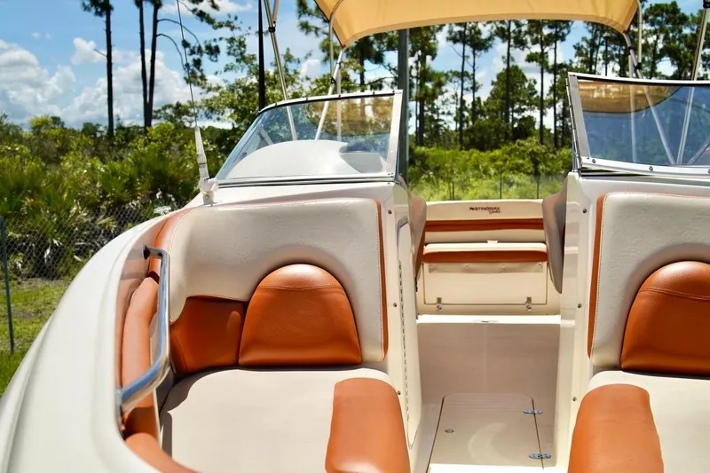  Yacht Photos Pics 2001 Stingray 240 LS boat interior with tan and orange seating, under a sunny sky.