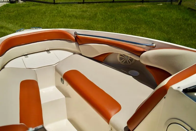  Yacht Photos Pics Interior of a 2001 Stingray 240 LS boat with orange and white seating.