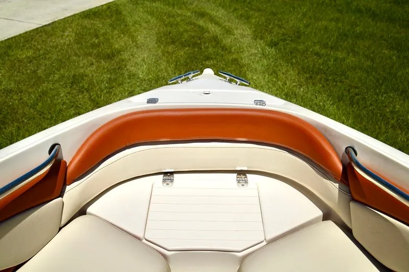  Yacht Photos Pics Bow seating area of a 2001 Stingray 240 LS boat with tan and orange upholstery.
