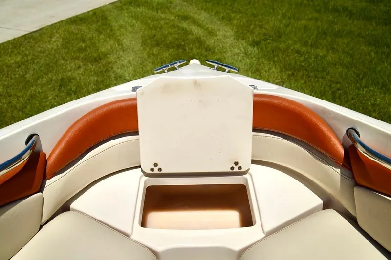 Yacht Photos Pics Interior of 2001 Stingray 240 LS boat with orange and cream seating.