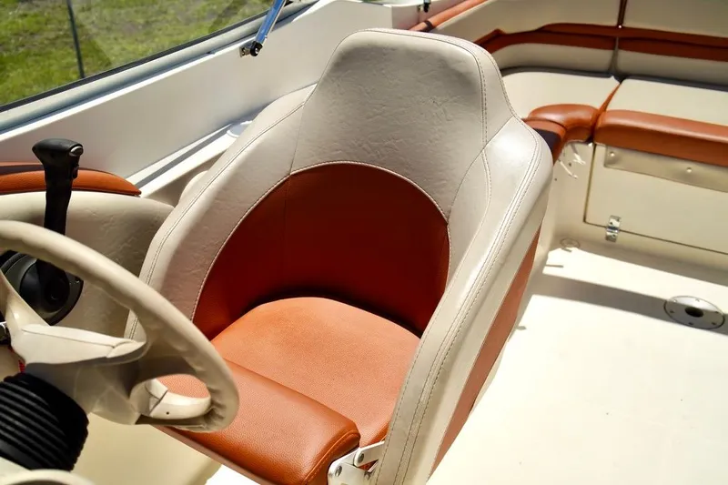  Yacht Photos Pics 2001 Stingray 240 LS boat interior with tan and brown seating.