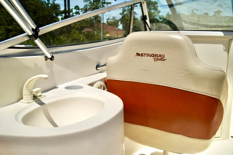  Yacht Photos Pics Interior of a 2001 Stingray 240 LS boat featuring a sink and branded seat.