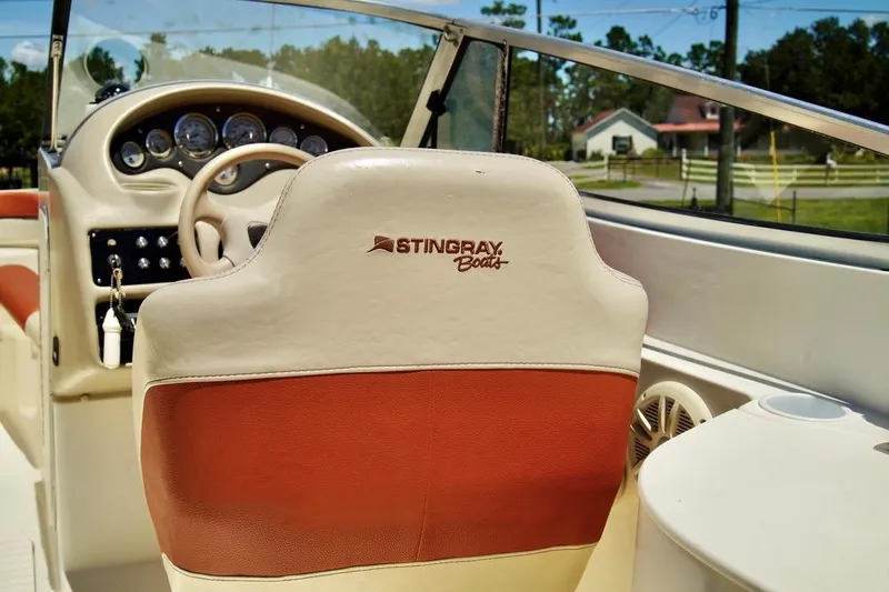  Yacht Photos Pics Interior of a 2001 Stingray 240 LS boat, featuring steering wheel and dashboard.