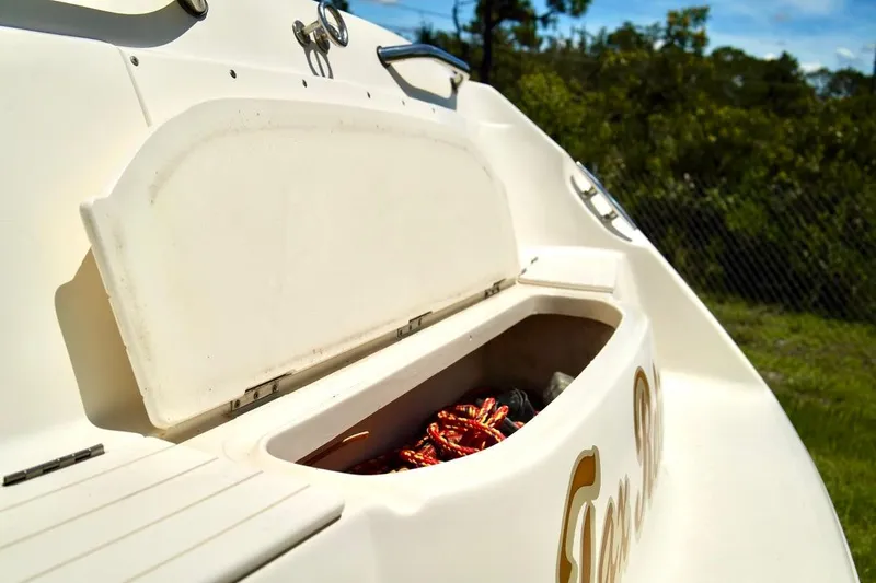  Yacht Photos Pics Open storage compartment on a 2001 Stingray 240 LS boat, with ropes inside.