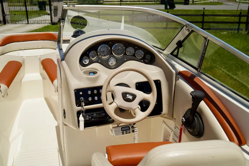  Yacht Photos Pics 2001 Stingray 240 LS boat interior with steering wheel and dashboard controls.