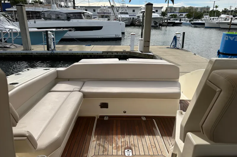 Yolo Or 2 Yacht Photos Pics 2014 Pursuit SC 365i Sport Coupe interior with docked boats in marina background.