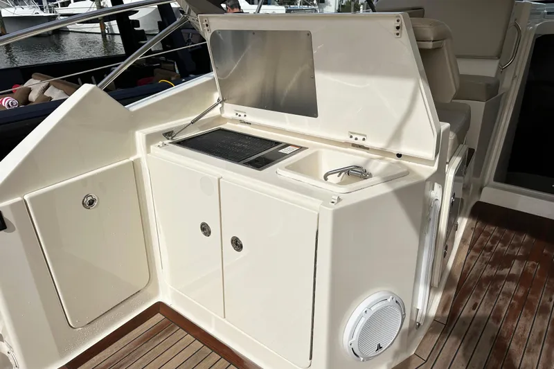 Yolo Or 2 Yacht Photos Pics 2014 Pursuit SC 365i Sport Coupe yacht interior with sink and storage area.