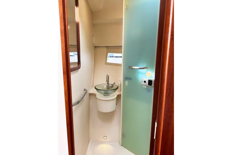 Yolo Or 2 Yacht Photos Pics 2014 Pursuit SC 365i Sport Coupe bathroom with glass sink and frosted door.