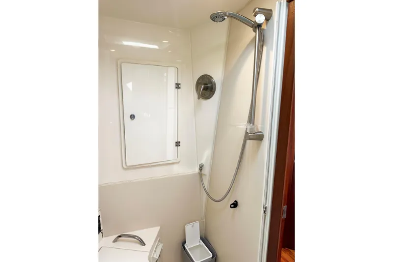Yolo Or 2 Yacht Photos Pics 2014 Pursuit SC 365i Sport Coupe shower area with modern fixtures and storage cabinet.