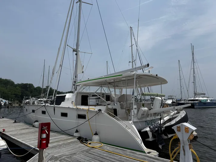 Two Fish Yacht Photos Pics 2021 Antares 44GS catamaran docked at a marina, featuring sleek design and modern amenities.