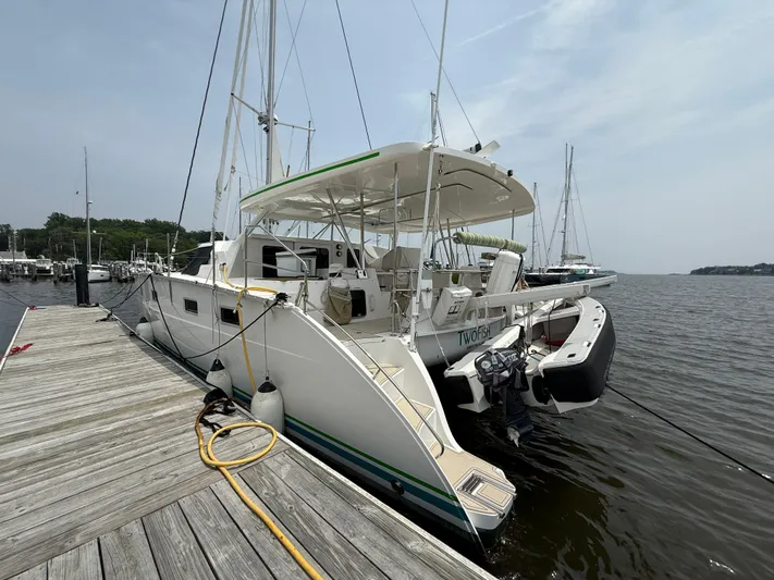 Two Fish Yacht Photos Pics 2021 Antares 44GS catamaran docked at a marina, rear view.