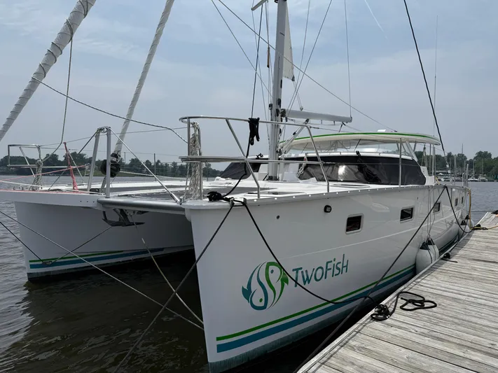 Two Fish Yacht Photos Pics 2021 Antares 44GS catamaran "TwoFish" docked at marina, side view.