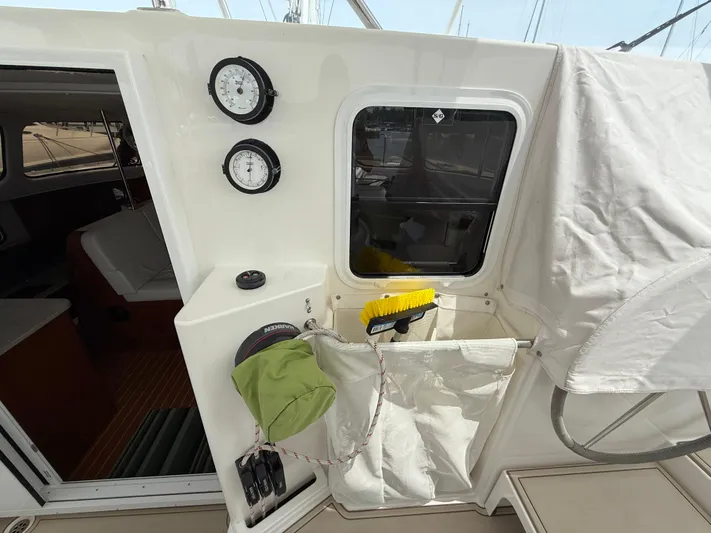 Two Fish Yacht Photos Pics 2021 Antares 44GS yacht cockpit with gauges, storage, and cleaning tools.