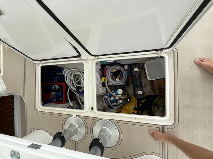 Two Fish Yacht Photos Pics Storage compartment on 2021 Antares 44GS boat, containing various tools and equipment.