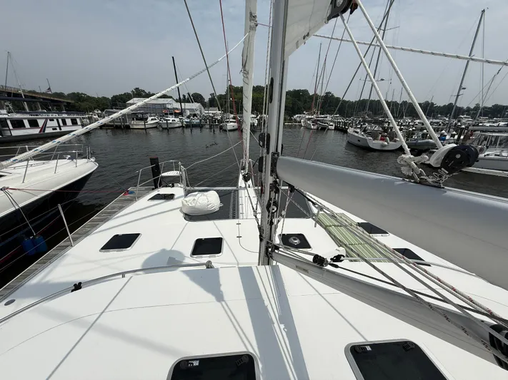 Two Fish Yacht Photos Pics Sailing yacht Antares 44GS, 2021 model, docked in a marina with other boats.